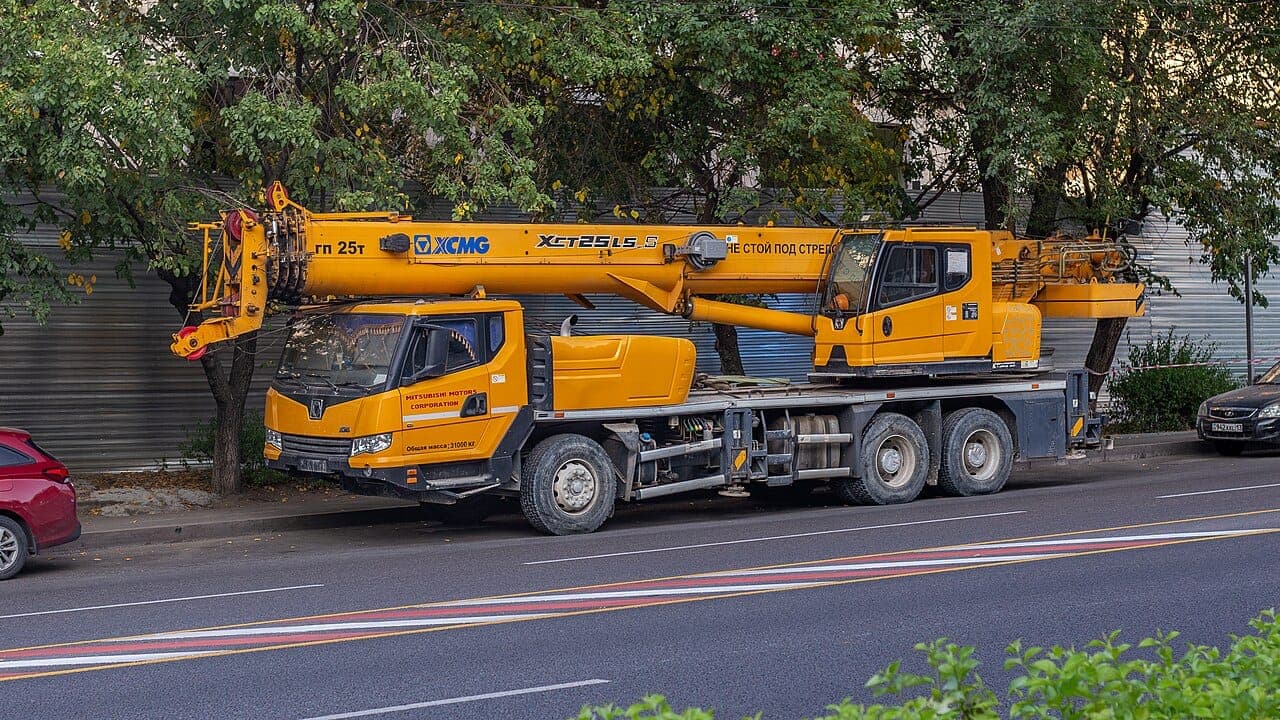 Yellow truck crane parked on a city street