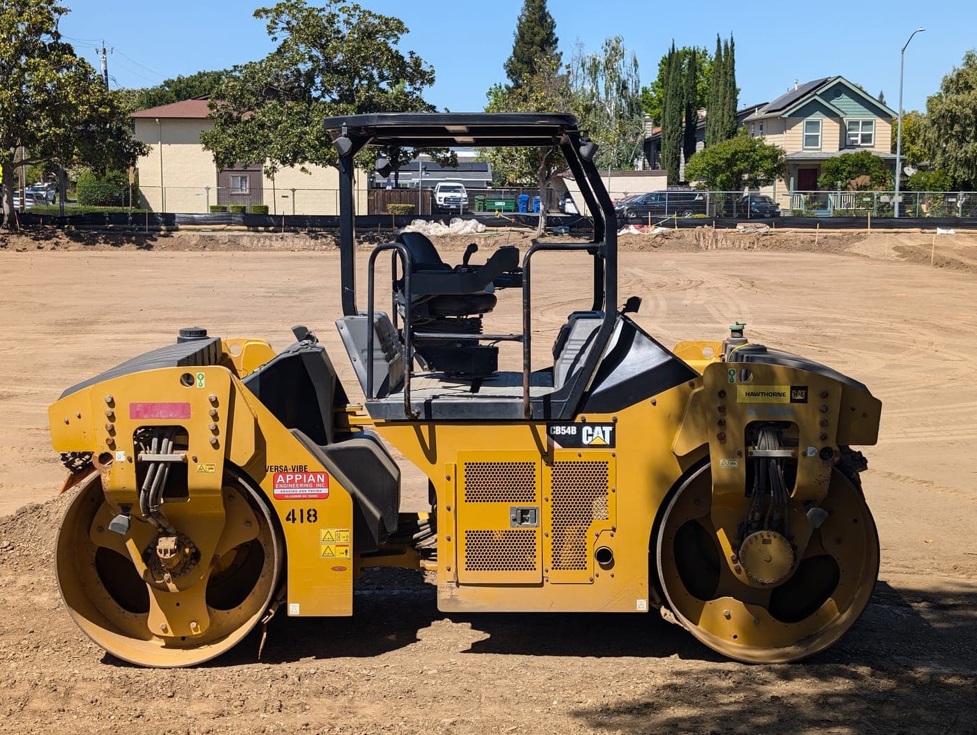 Tandem drum road roller on a dirt lot